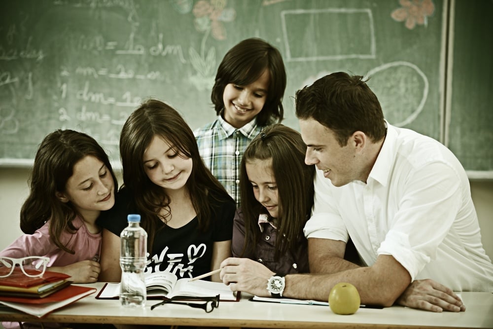 Cheerful kids at school room having education activity