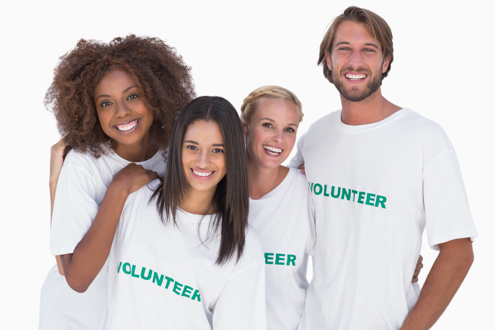 Smiling group of volunteers on white background